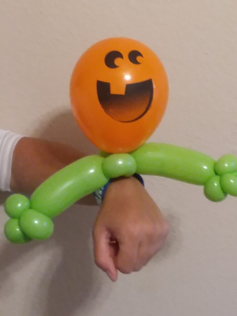 Orange smiley balloon bracelet with green twisted balloons